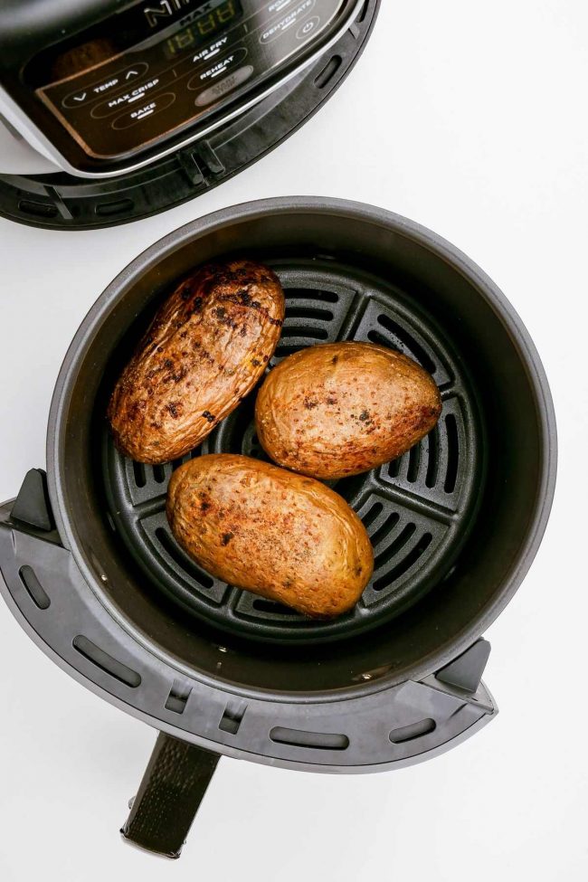 https://www.texanerin.com/content/uploads/2021/05/air-fryer-baked-potatoes-in-basket-2-650x975.jpeg
