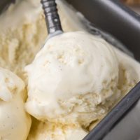 Close-up photo of a scoop of French vanilla ice cream being scooped out of a pan