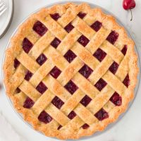 Overhead image of a tart cherry pie with a decorative lattice crust on top