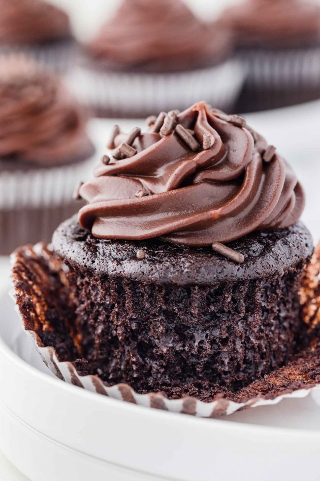 A cupcake with the liner halfway removed