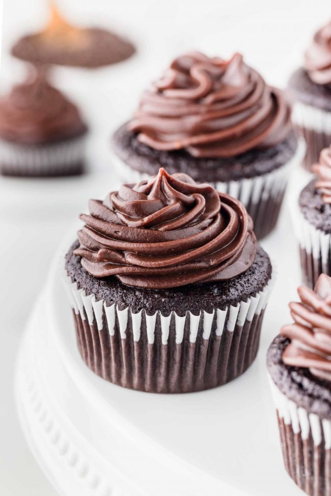 Chocolate cupcake on a white cake stand