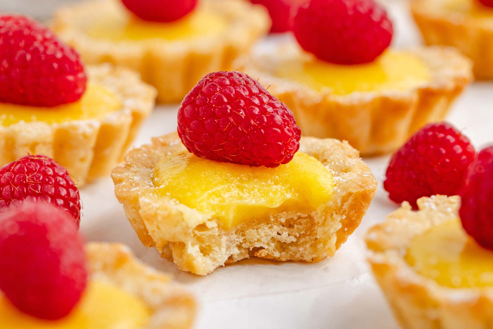 close-up of lemon tartlet with bite taken out