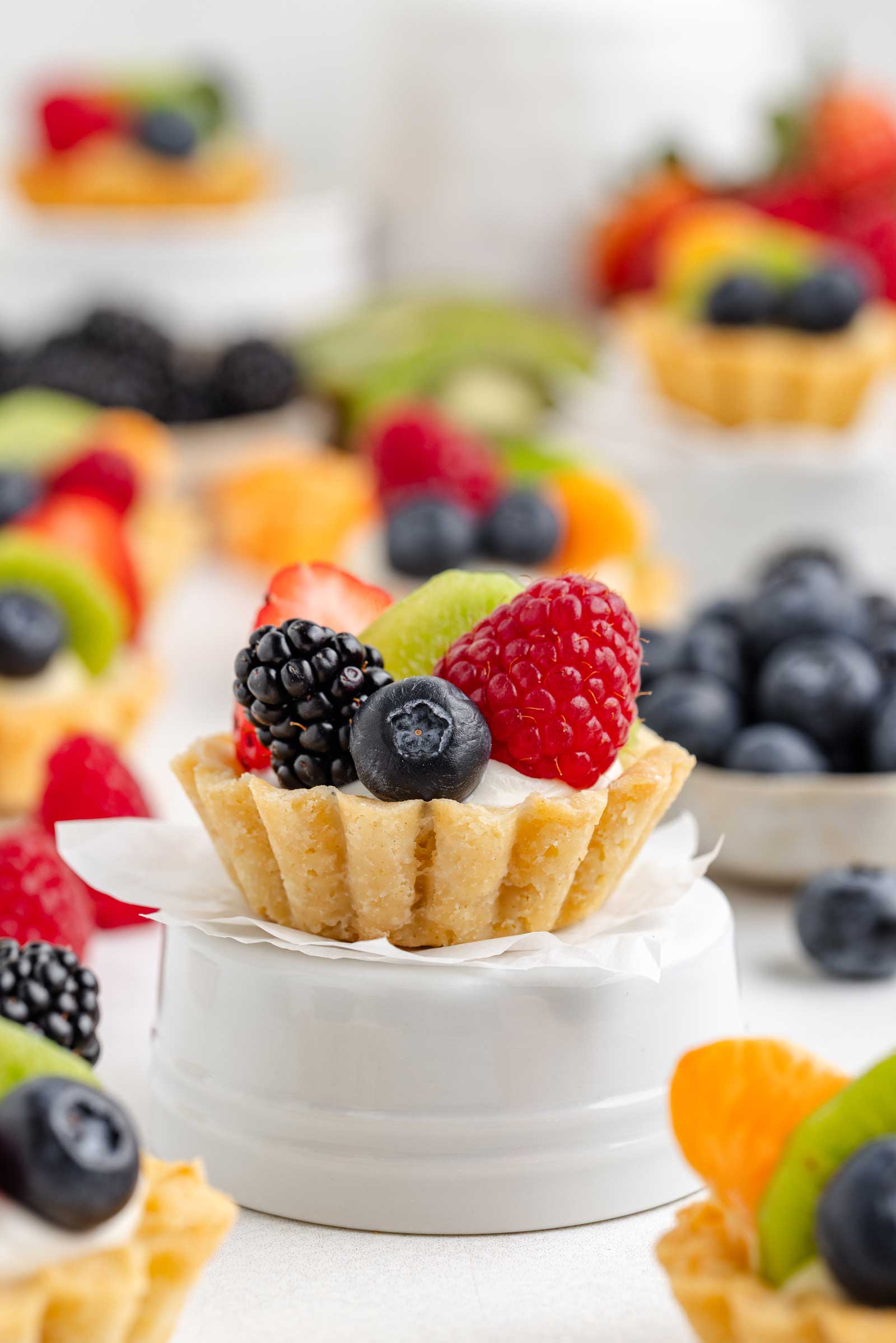 fruit tartlet sitting on an upside down white ramekin