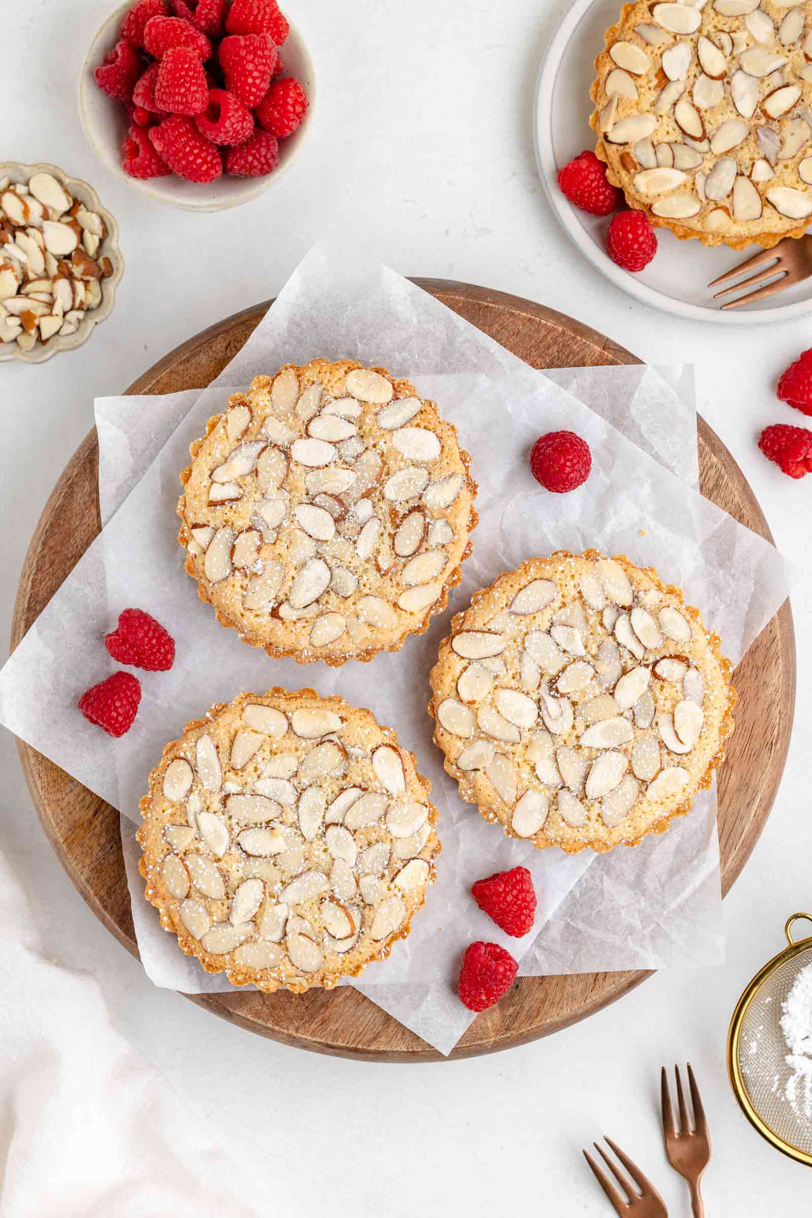 3 frangipane tartlets on wooden cutting board
